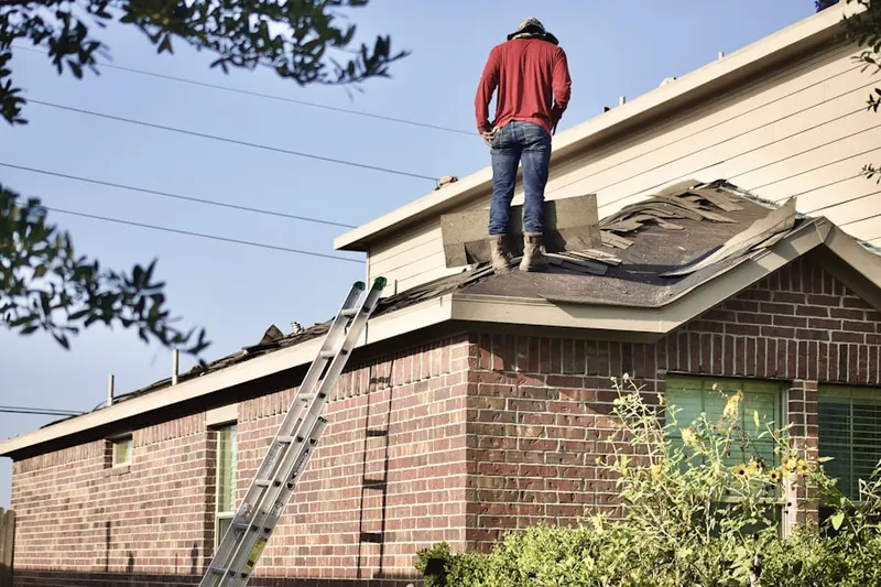 Professional roofer working on a residential roof in Martins Corner